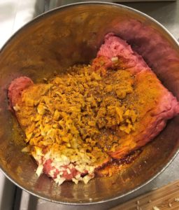 färs, lök och kryddor i bunke